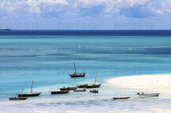 Fishing boats in turquoise green water on the beach of Kendwa, Zanzibar