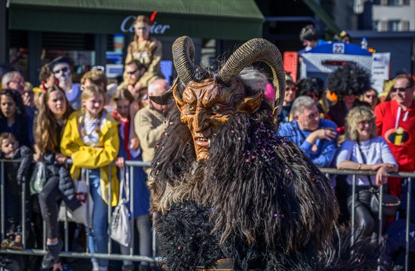 Masked person with devil mask, Carnival parade of the Wey Guild on Rose Monday