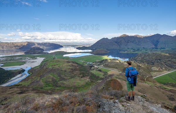 Hiker on the hiking trail to Rocky Peak, views of Wanaka Lake and mountains