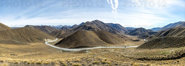 Barren mountain landscape with pass road, Lindis Pass