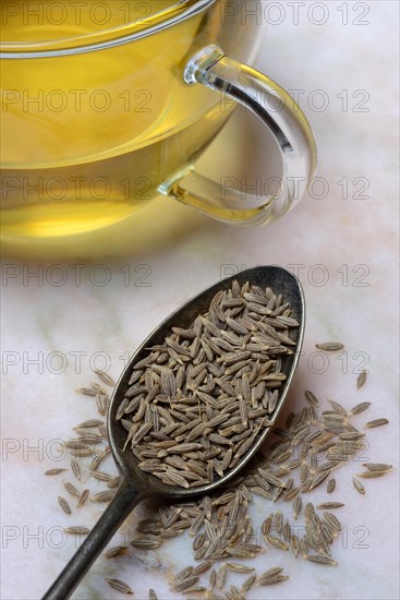 Caraway in spoon and cup caraway tea, food photography