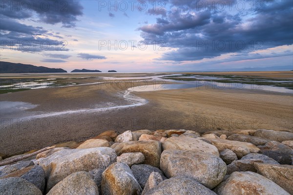 Evening mood at low tide, sand formations on the coast of Torrent Bay