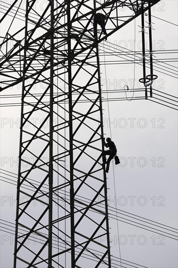 High voltage engineers working on high voltage pylons, Baden-Wuerttemberg