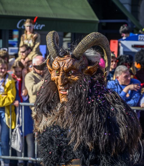 Masked person with devil mask, Carnival parade of the Wey Guild on Rose Monday