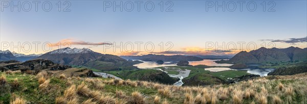 Sunset, panorama view on Wanaka Lake and mountains