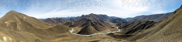 Barren mountain landscape with pass road, Lindis Pass