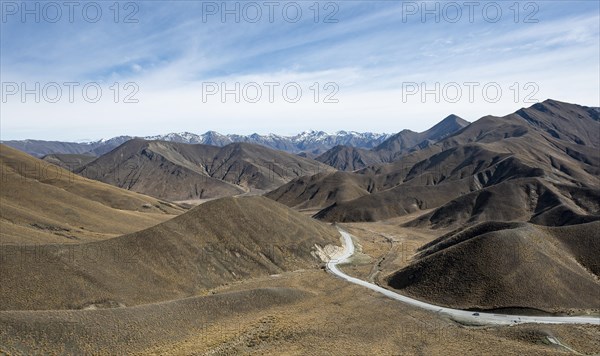 Barren mountain landscape with pass road, Lindis Pass