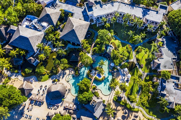 Beach of Flic en Flac with the luxury hotel Sugar Beach Golf & Spa Resort and palm trees, Mauritius