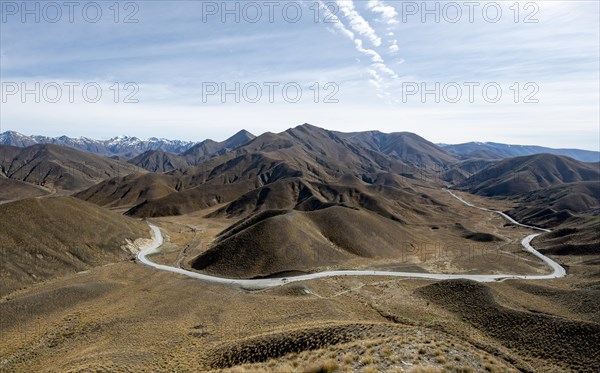 Barren mountain landscape with pass road, Lindis Pass