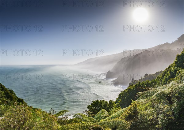 View from the coastal road, unspoiled rocky coast with sea spray