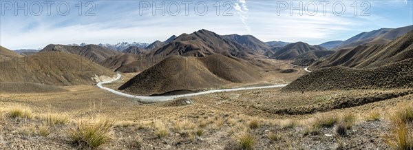 Barren mountain landscape with pass road, Lindis Pass