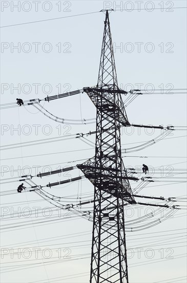 High voltage engineers working on high voltage pylons, Baden-Wuerttemberg