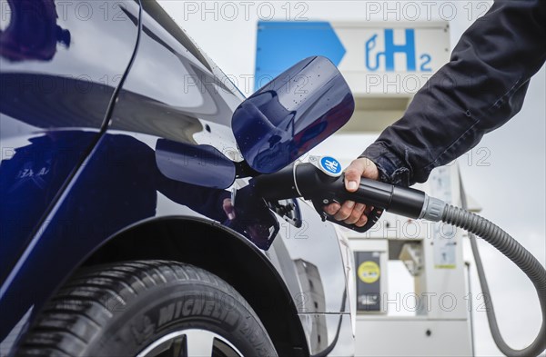 Passenger car refuels H2 hydrogen at a H2 hydrogen filling station, Herten