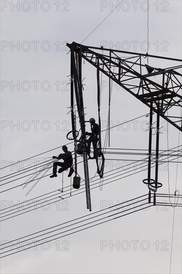 High voltage engineers working on high voltage pylons, Baden-Wuerttemberg