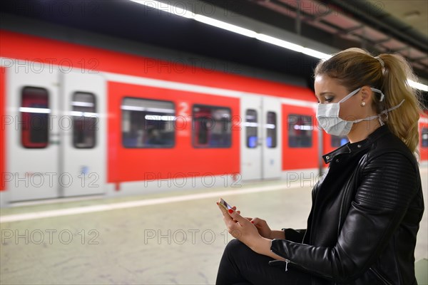 Woman with face mask, on mobile phone