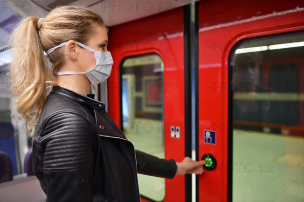 Woman with a face mask, standing in the S-Bahn