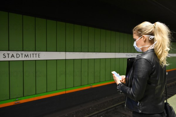 Woman with face mask, on mobile phone