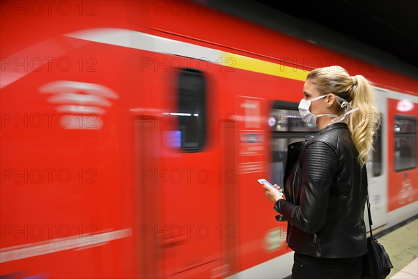 Woman with face mask, on mobile phone