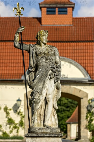 Sculpture of the sea god Neptune at the Neptune Fountain, farm yard in the baroque castle Fasanerie