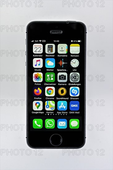 IPhone with different apps on display, cutout