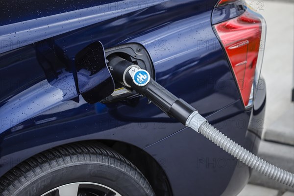 Passenger car refuels H2 hydrogen at a H2 hydrogen filling station, Herten