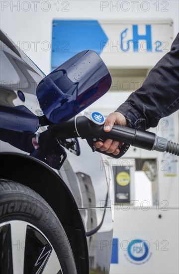 Passenger car refuels H2 hydrogen at a H2 hydrogen filling station, Herten