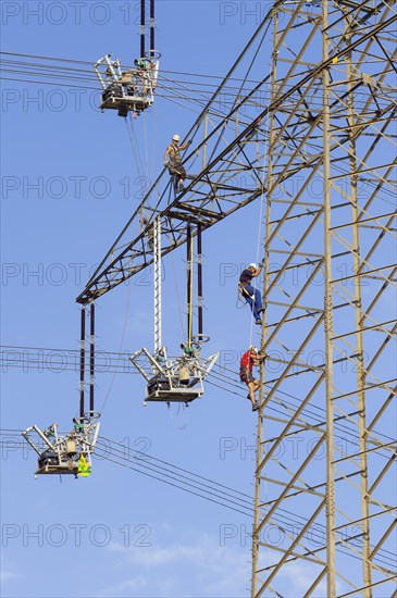 High voltage engineers working on the high voltage pylon, Baden-Wuerttemberg