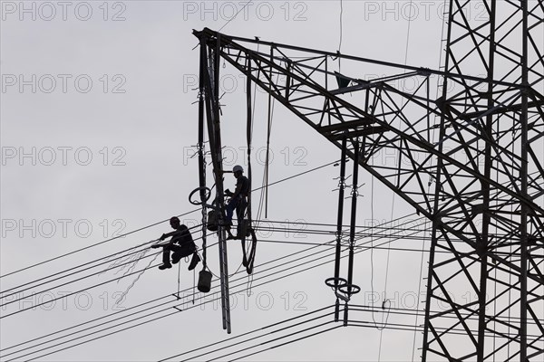 High voltage engineers working on high voltage pylons, Baden-Wuerttemberg