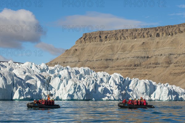 Rubber dinghies with tourists in front of glaciers, Croker Bay