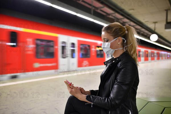 Woman with face mask, on mobile phone