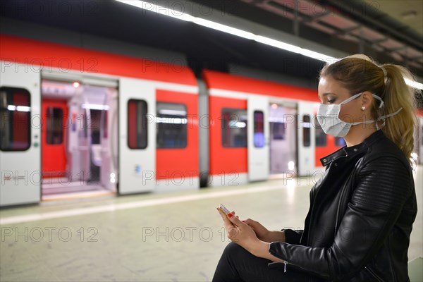 Woman with face mask, on mobile phone