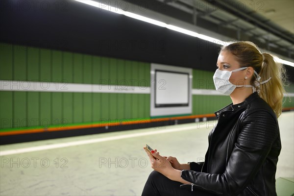 Woman with face mask, on mobile phone