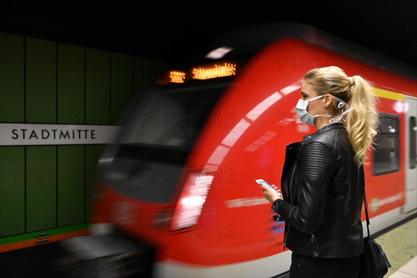 Woman with face mask, on mobile phone