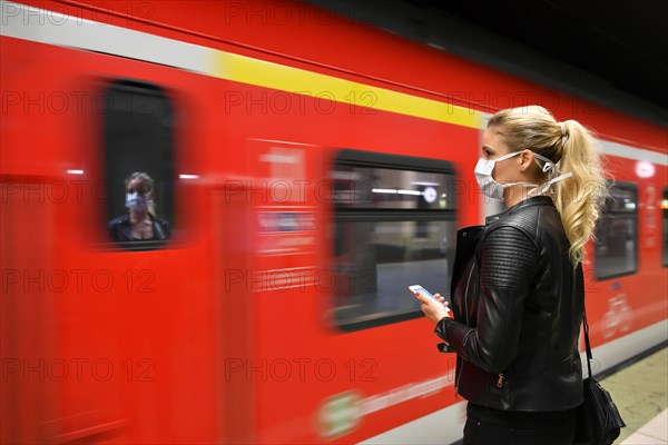 Woman with face mask, on mobile phone