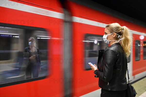 Woman with face mask, on mobile phone