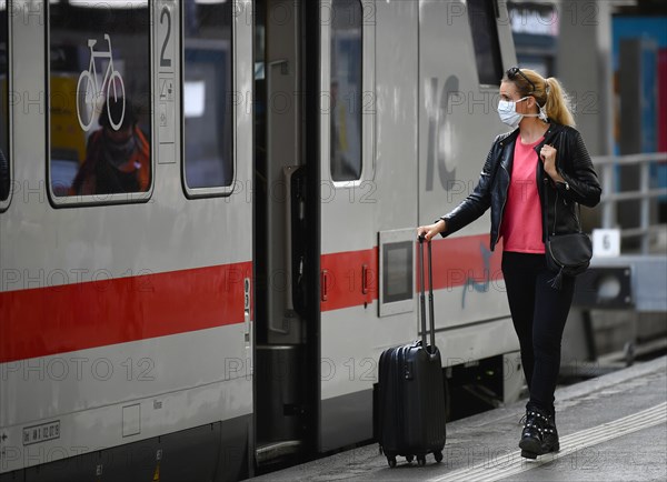 Woman with face mask, waiting for train