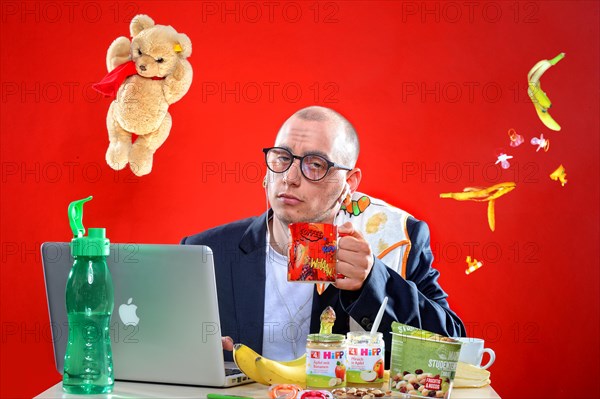 Young man with snacks in front of notebook