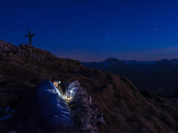 Mountaineer bivouacs at the summit of the Berchtesgadener Hochthron