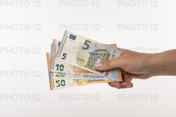 Woman holding fanned euro banknotes in her hand