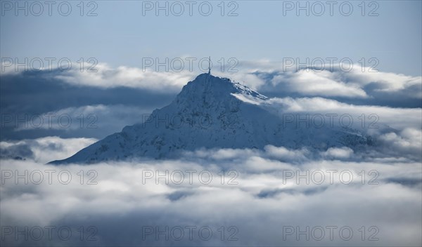 View of snow-covered Kitzbuehler Horn between clouds