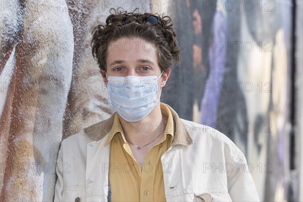 Young man wearing a mouth protection mask
