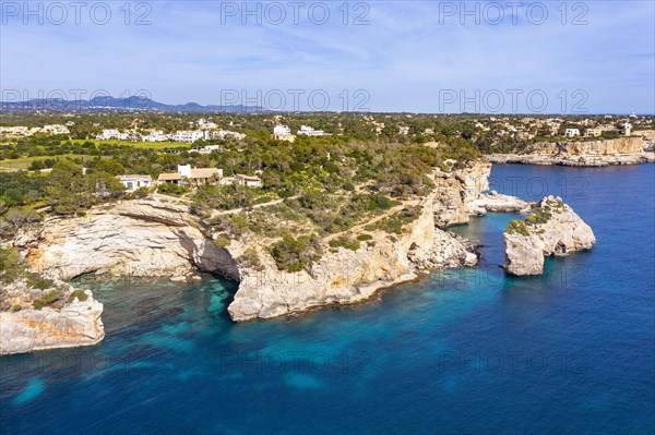 Rocky coast with rock gate Es Pontas in the sea