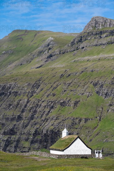 Small church with grass roof in mountain landscape