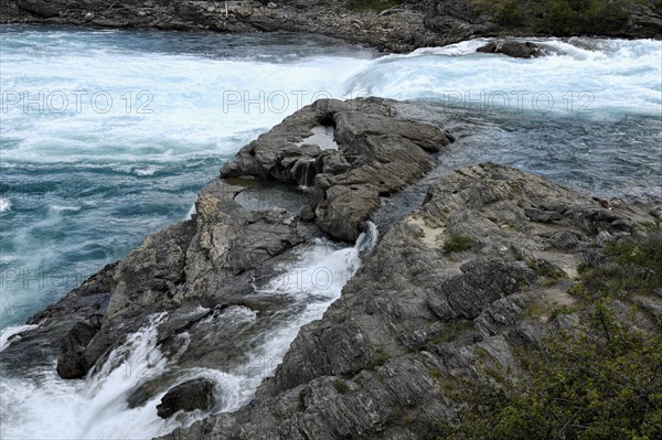 Rapids at the confluence of blue Baker river and grey Neff river