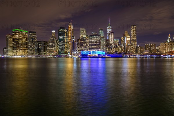 View from Pier 1 at night over the East River to the skyline of lower Manhattan