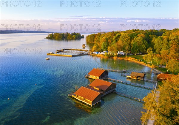 Boathouses and Rose Island in Lake Starnberg near Feldafing in the morning light
