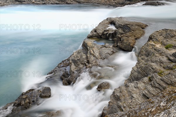 Rapids at the confluence of blue Baker river and grey Neff river