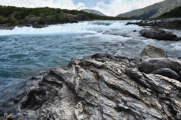 Rapids at the confluence of blue Baker river and grey Neff river