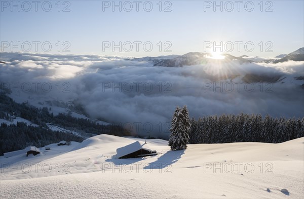 View of the Brixen Valley with morning sun and high fog in winter