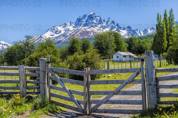 Gate along a dirt road and view of the Castillo mountains
